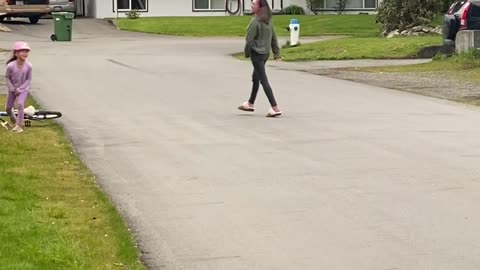 Little Girl Learning to Ride a Bike