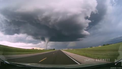 Storm chasing dashcam: Tornado crossing the highway! Laramie, Wyoming