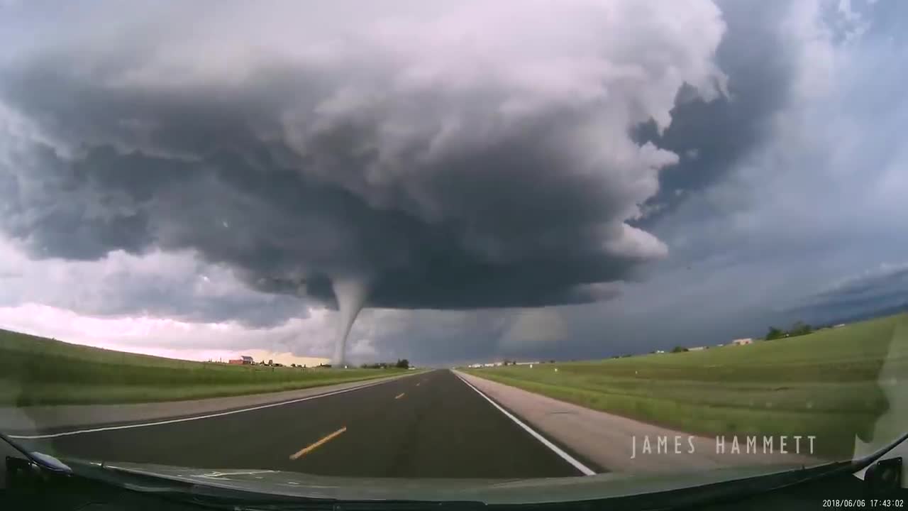 Storm chasing dashcam: Tornado crossing the highway! Laramie, Wyoming