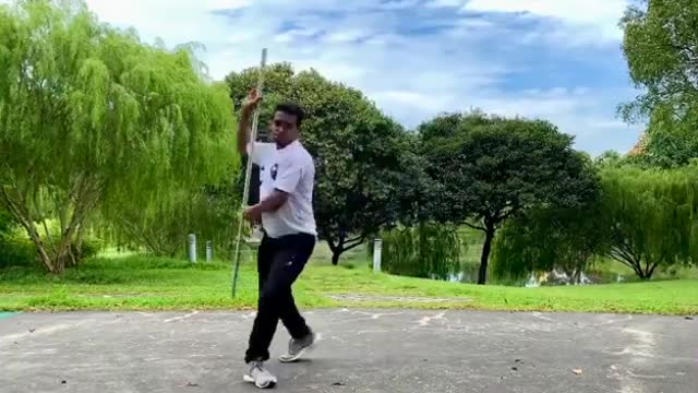 Man Performs Indian Martial Art Form Silambam Using Bamboo For Fencing