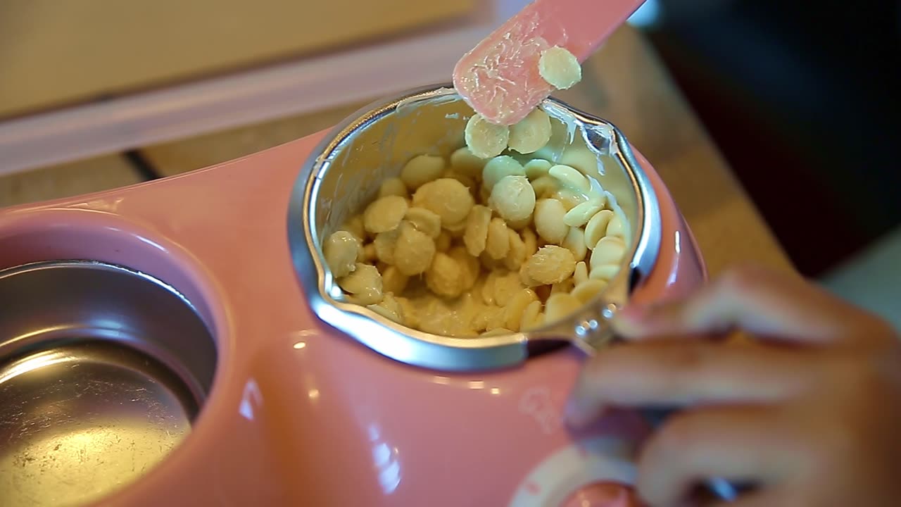 The hand of the person melting the white chocolate