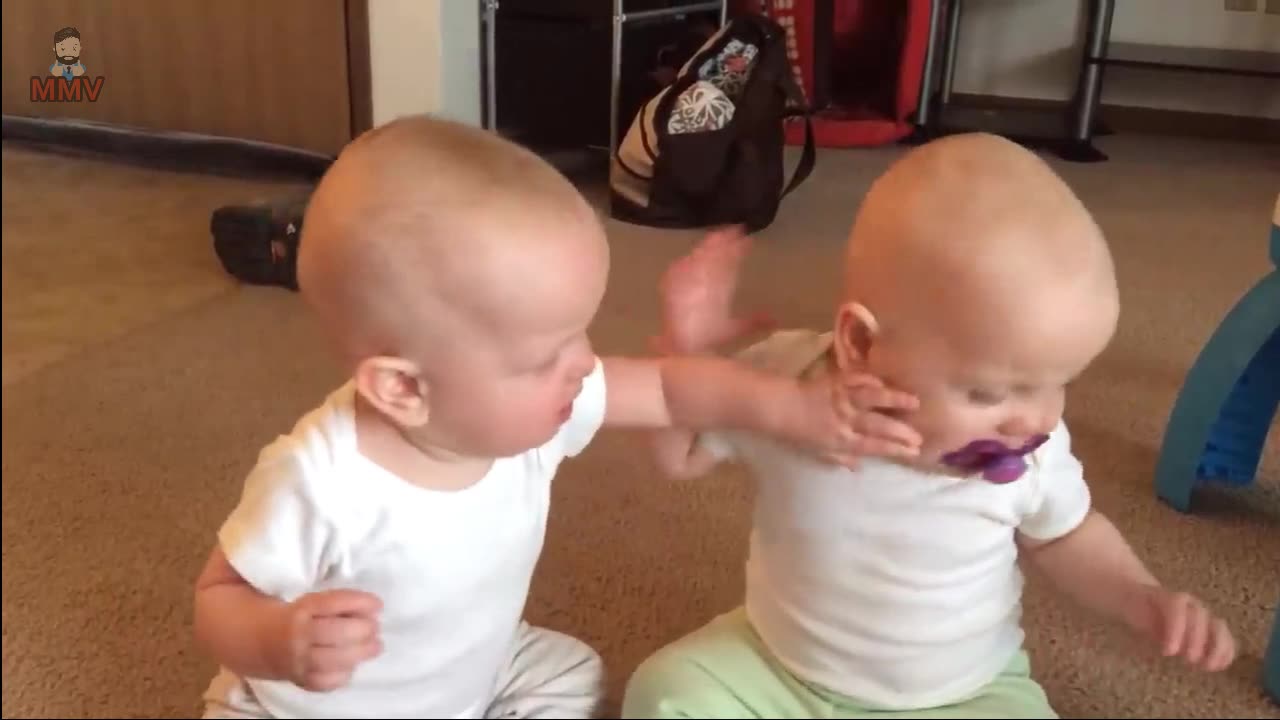 Twin baby girls fight over pacifier