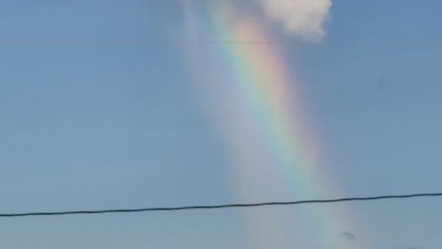 Rainbow Appears to Pour Out of Cloud