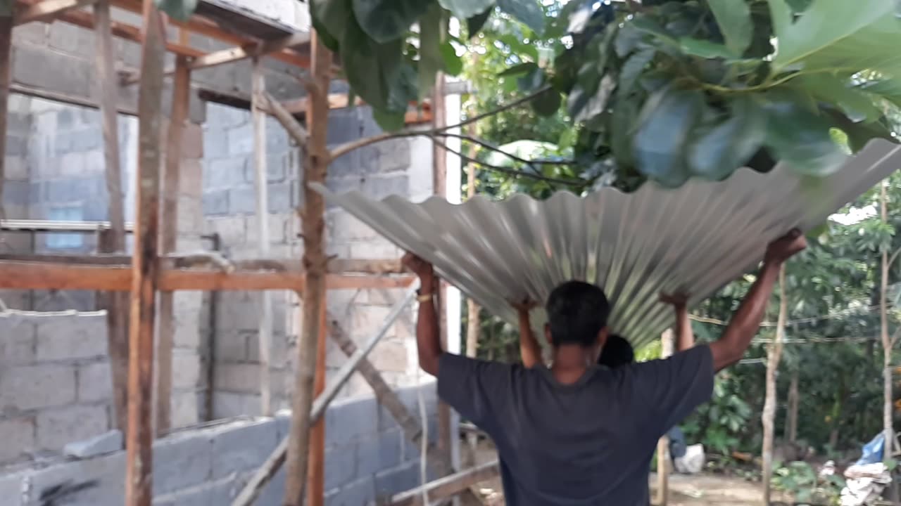 Moving roof material to the staging area.
