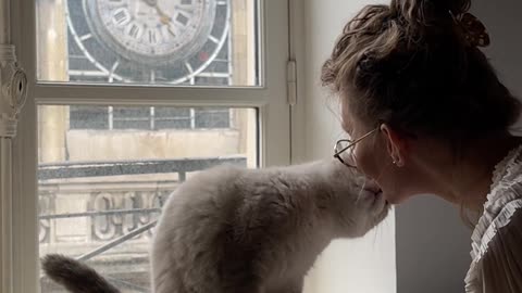 A Woman Kissing her Cat