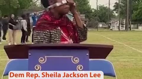 Shelia Jackson putting on her eclipse glasses.