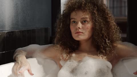 A Woman Relaxing Herself In A Bathtub