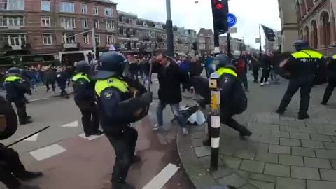 People beaten with batons at unauthorized protest against COVID restrictions in Amsterdam.