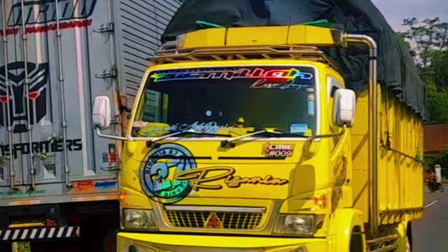 The seconds of the modif truck passing over the railroad