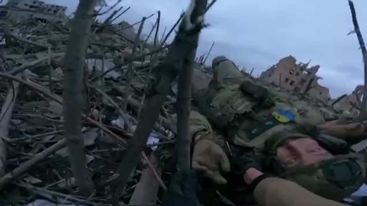 AFU soldiers evacuate a wounded comrade in Marinka.