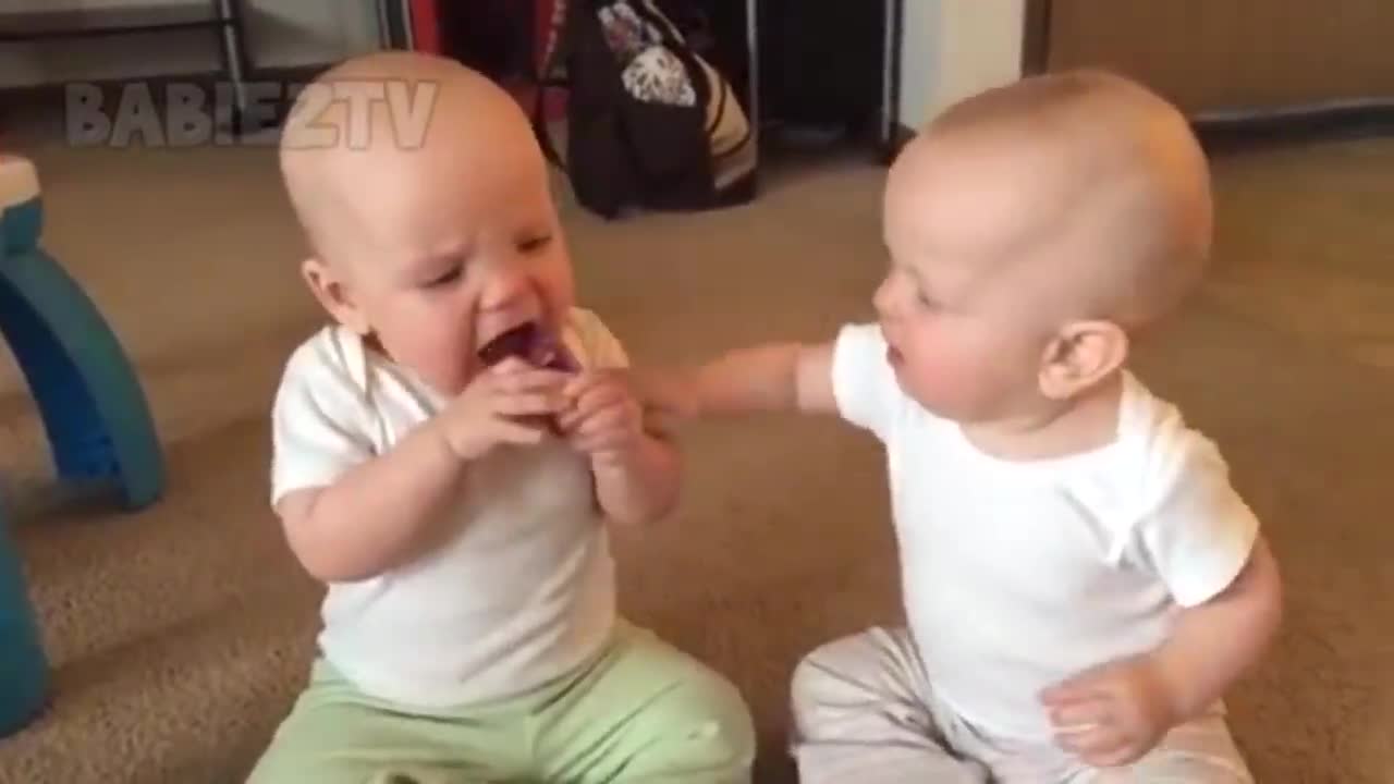 Funny twin baby girls fighting over pacifiers