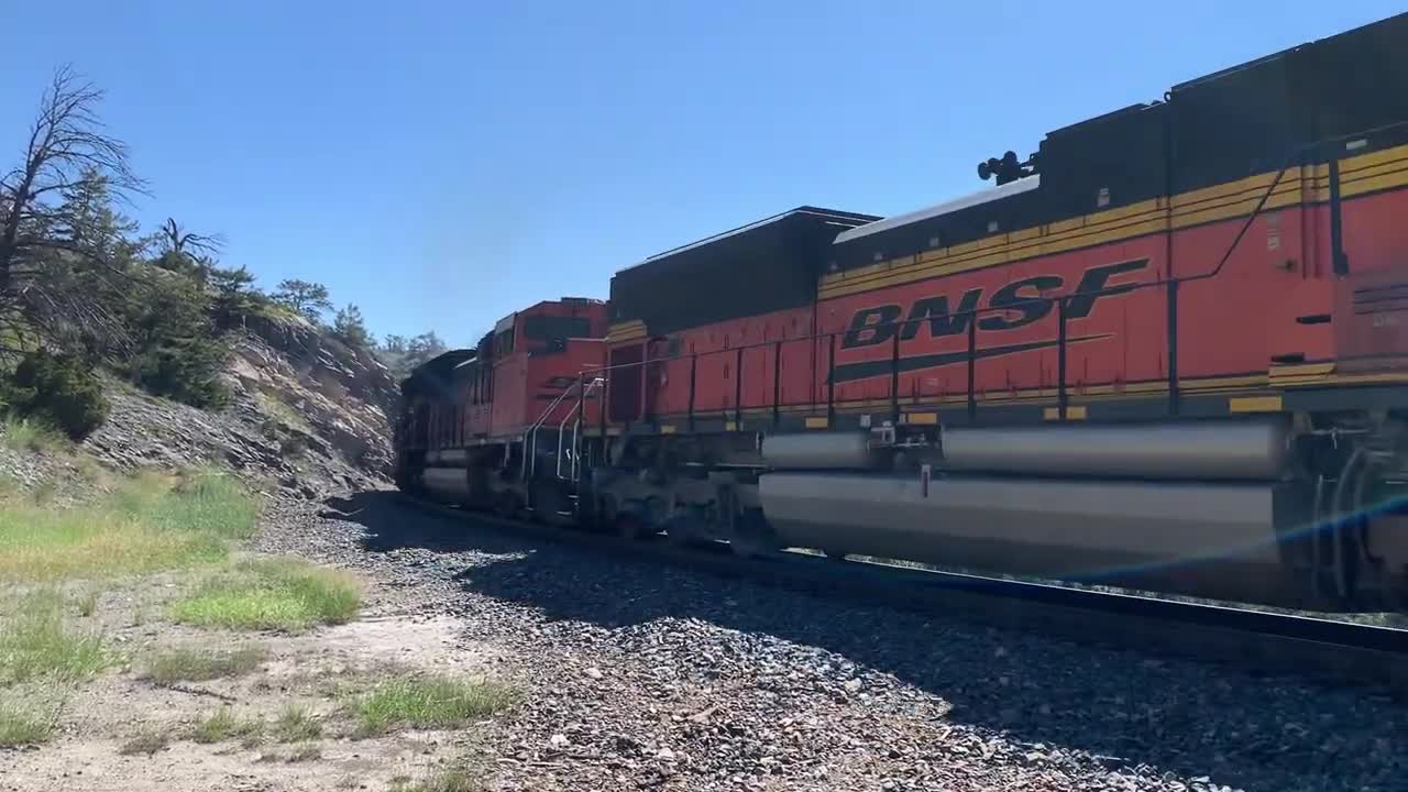 Solid EMD SD70ACe lineup up Mullan Pass. 3 BNSF, 4 MRL, then 1 BNSF on the rear.