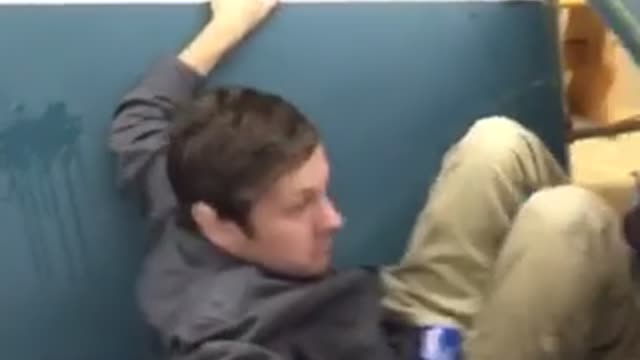 Guy falls from ceiling onto table and breaks it
