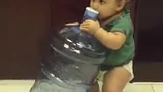 Thirsty baby tries to drink from 5 gallon water jug