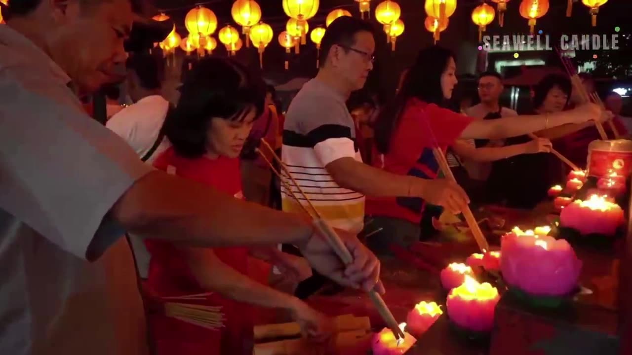 People celebrating the New Year light lotus candles in Chinese temples.