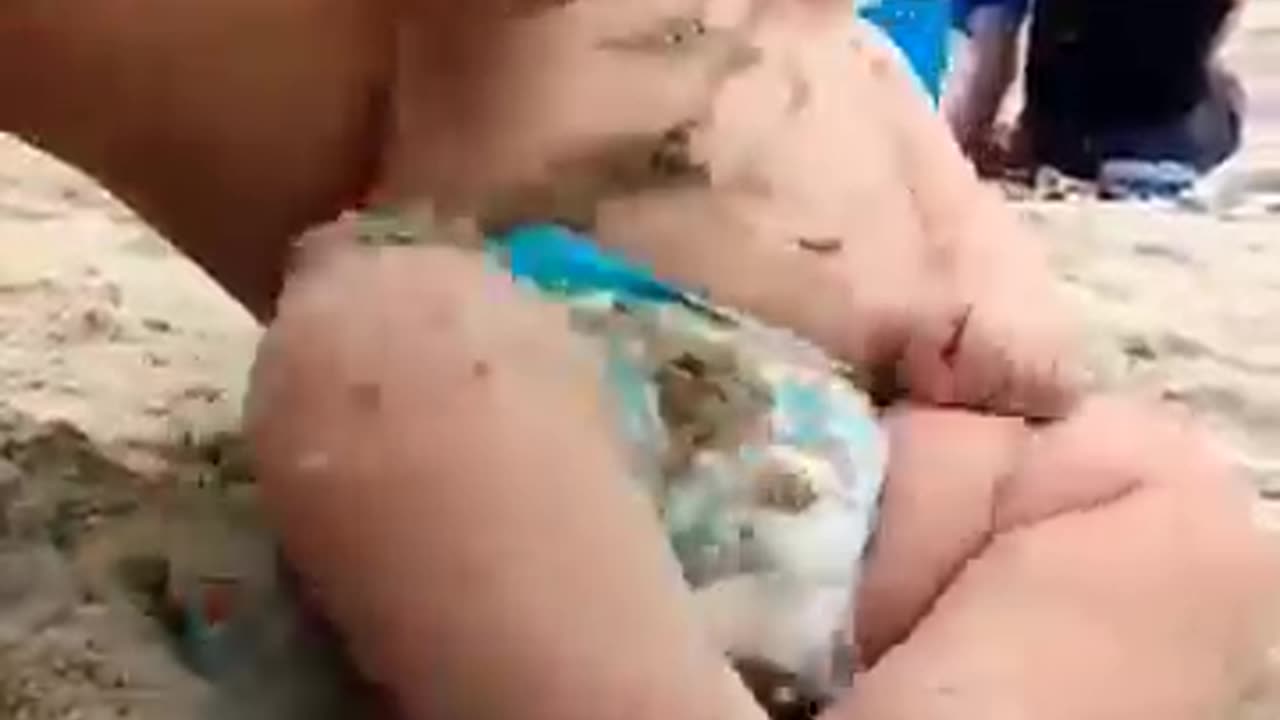 Funny baby reaction on beach