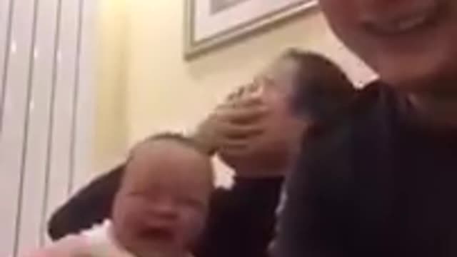 The baby laughed when he saw his father counting the money