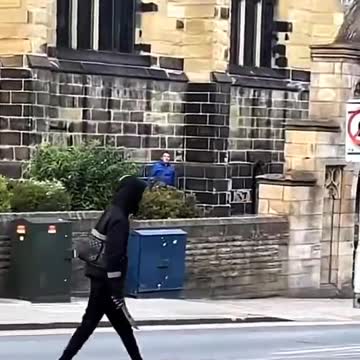 Video recorded in Huddersfield, England yesterday shows a person using a long blade to attack a man