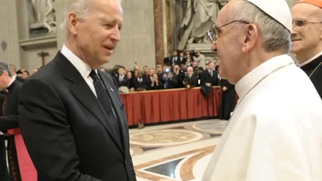 Biden having a discussion with the Pope