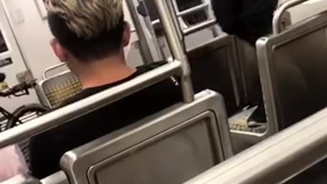 Guy red shirt standing on subway seats