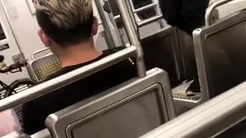 Guy red shirt standing on subway seats