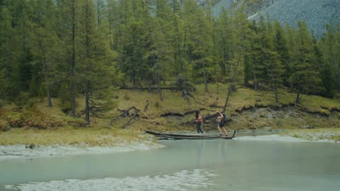 Couple Crossing on River