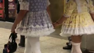 Two old men dressed in dressed like dolls
