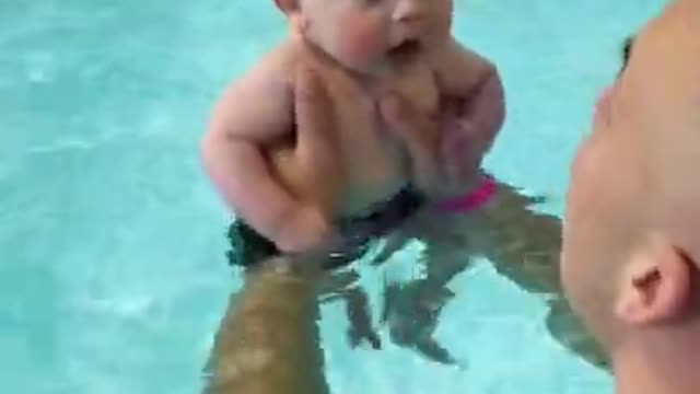 Cute baby swimming with dad 🐥