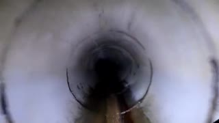 Dirt Bike Rider Skillfully Navigates through Drainage Tunnels