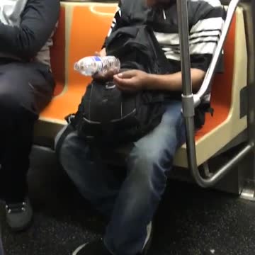 Guy falling asleep spills water on guy sitting next to him