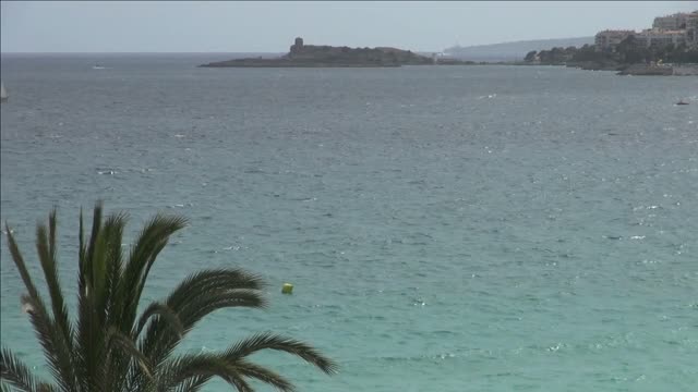 teal water off spanish shore