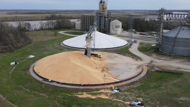 Hyper Lapse of Farmers Moving Grain at an Elevator