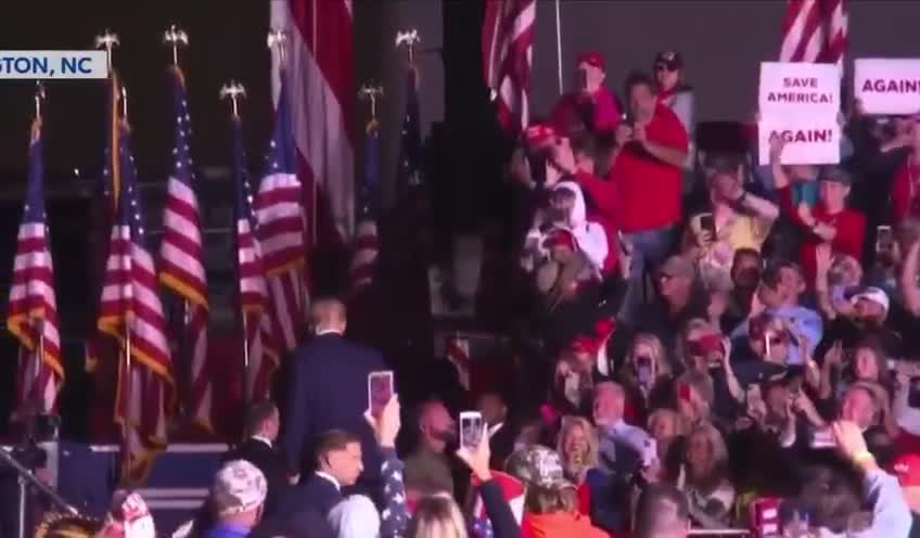 President Trump makes an air Q to one of the people in the stands as he leaves