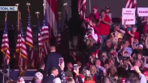 President Trump makes an air Q to one of the people in the stands as he leaves
