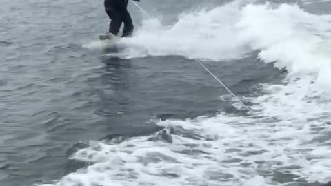 Guy water skiing in suit 2