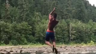 Rope swing fail guy spins flips and lands on back water lake