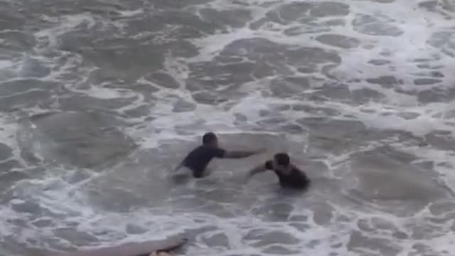 Music two guys one guy gets onto other guys surfboard then they wipe out