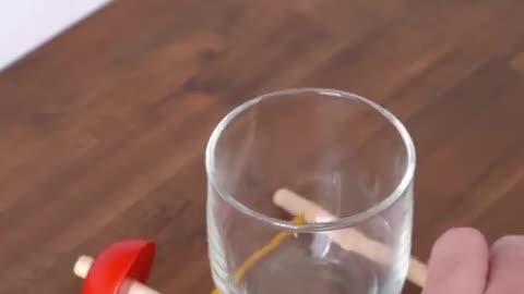 Challenge to lift the glass using a stick...