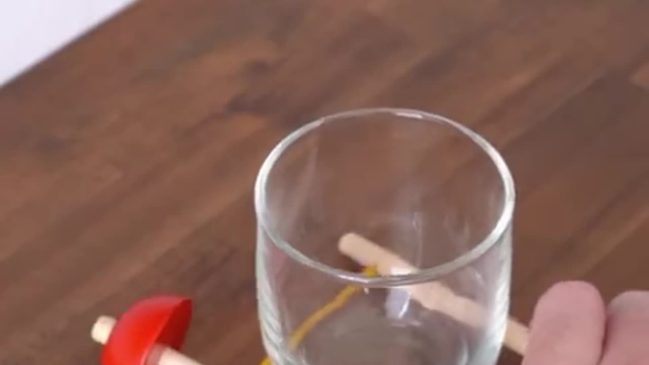 Challenge to lift the glass using a stick...