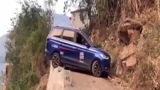 safety draving hazard- car driving on the edges of mud road