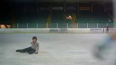 Figure skater slips and falls preparing for jump