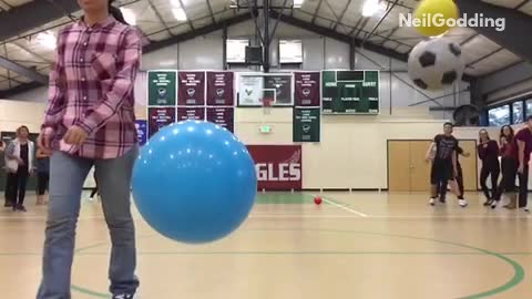 Slowmo teachers run past dodgeballs soccer ball hits camera