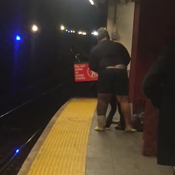 Guy takes off his pants in subway station