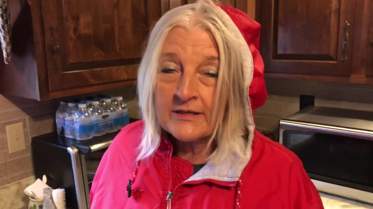 Red piketon jacket woman scared walking through door into kitchen