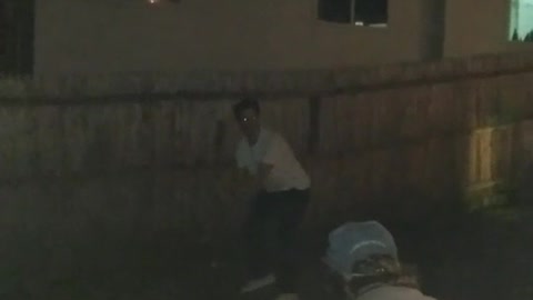 Guy white shirt hitting beer with bat and hitting camera
