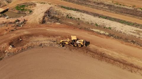 Caterpillar 140H road grader working