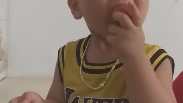 the baby eats sour plums