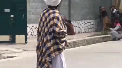 Taliban soldiers detaining people in the streets of Kabul.