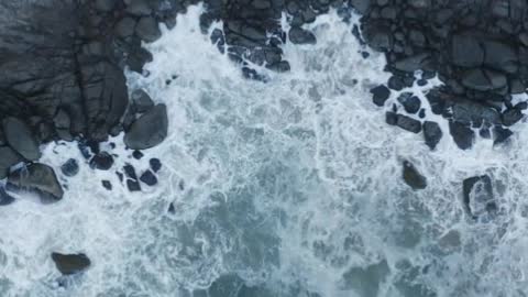 Top aerial shot of seashore with rocks