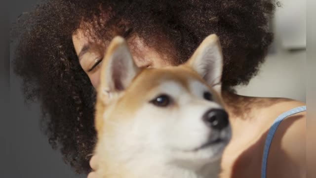 A Woman Embracing Her Pet Dog In Bad